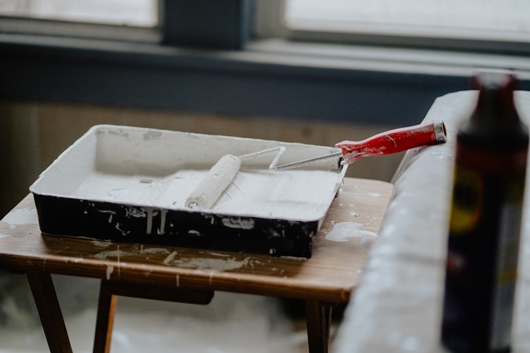 Paint roller applying fresh paint to an apartment wall during a turnover in Saint Paul, MN